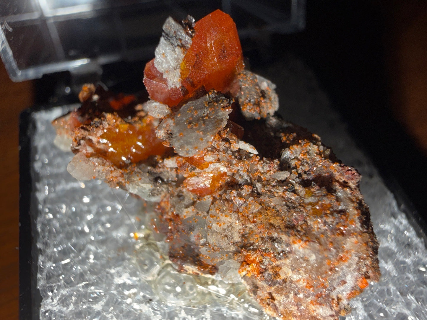 Wulfenite on Limonite/Goethite-rich host rock matrix specimen from red cloud mine, Arizona โ vivid orange-red wulfenite on earthy brown limonite matrix, vitrous to resinous luster, translucent to transparent, additional angle view โ WUL-0054