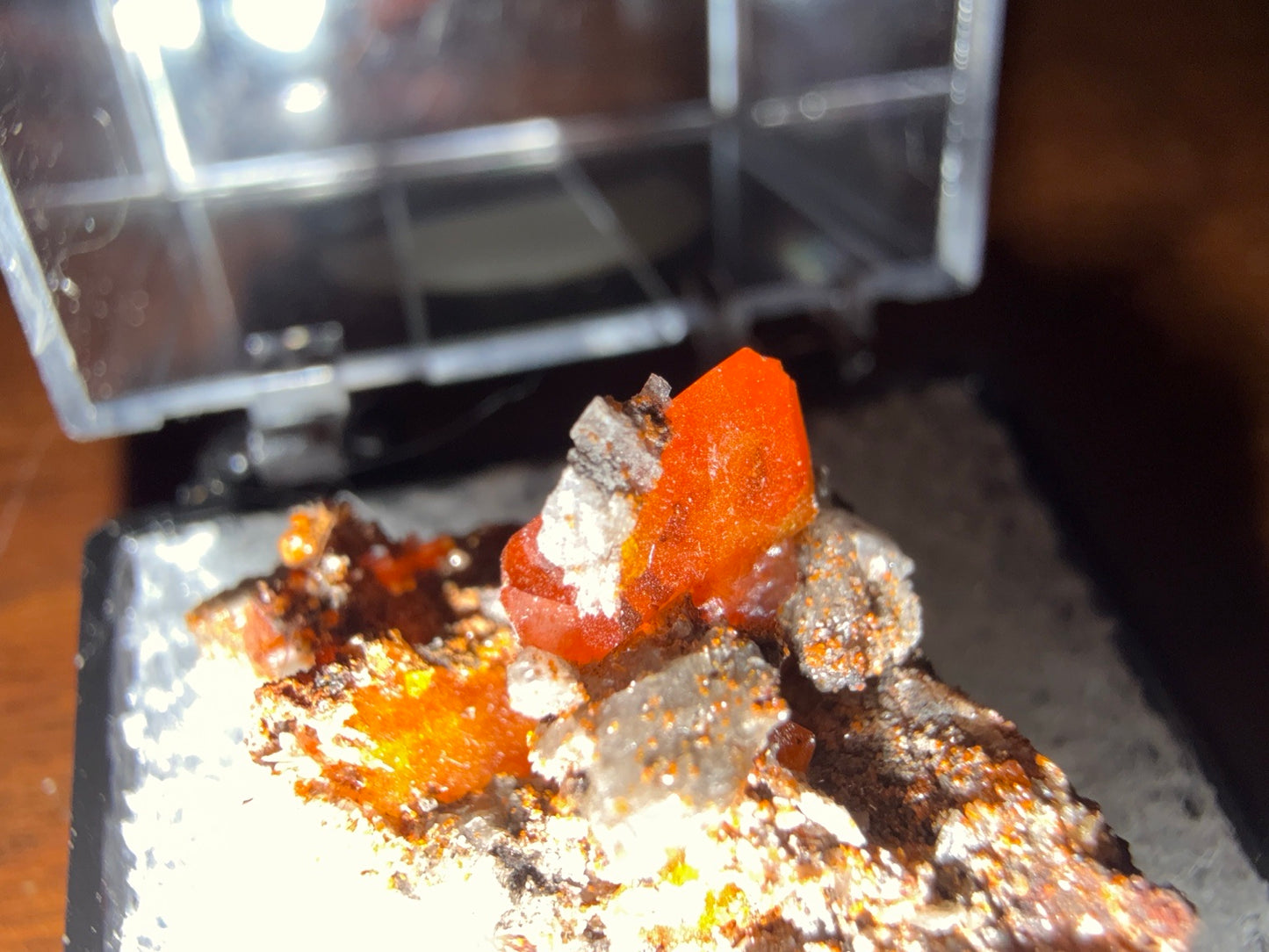 Wulfenite on Limonite/Goethite-rich host rock matrix specimen from red cloud mine, Arizona — vivid orange-red wulfenite on earthy brown limonite matrix, vitrous to resinous luster, translucent to transparent, additional angle view — WUL-0054