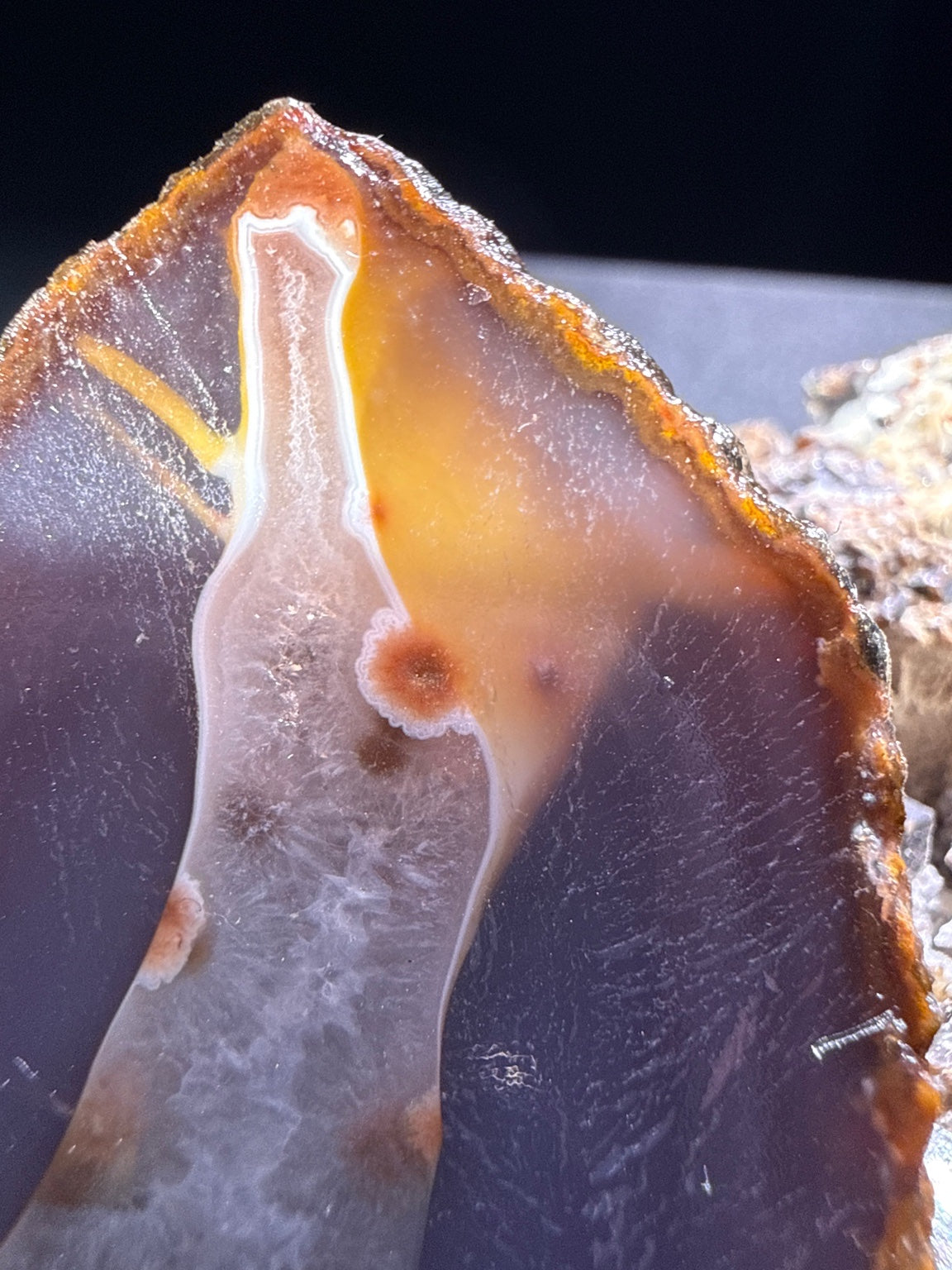 Zhanguo Agate specimen from Xuanhua, Zhangjiakou — purple-gray, orange-brown rimmed zhanguo agate with white banding, vitreous luster, translucent (7×4.3×3.85 cm), close-up detail of crystal structure — ZHA-0034
