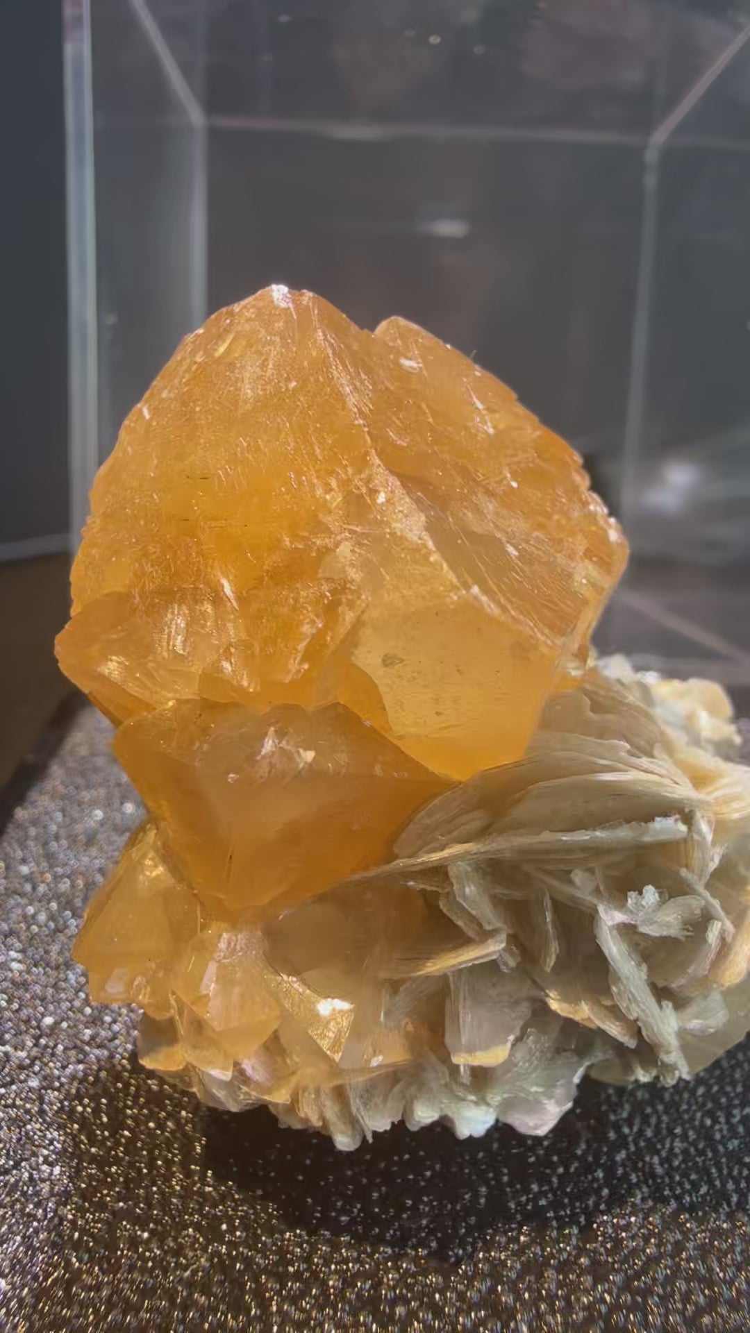 Scheelite with Muscovite specimen from Xuebaoding, Sichuan — fiery orange scheelite on silvery muscovite, vitreous to resinous (scheelite), pearly (muscovite) luster, translucent to transparent (scheelite), transparent on edges (muscovite) (4×4×5 cm), 360° rotation video — SCH-0042